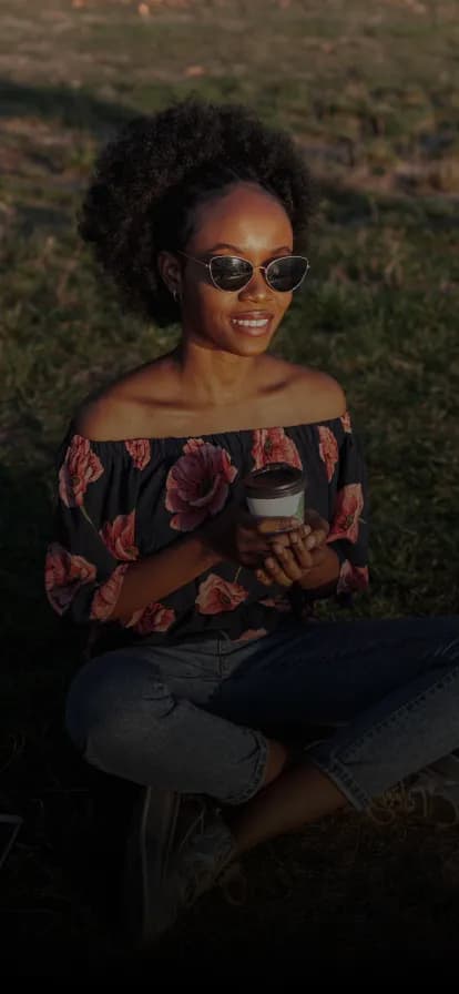 A smiling woman sitting outdoors